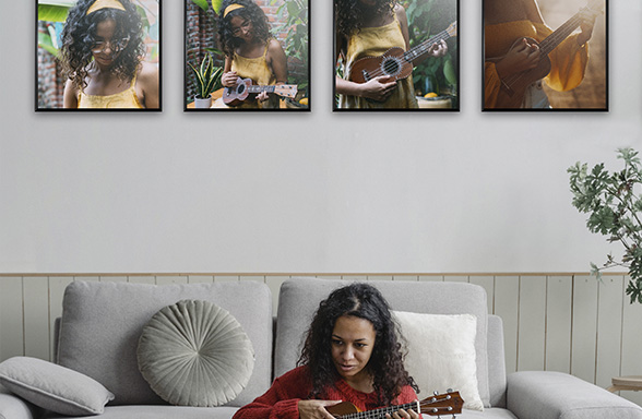 girl in a room playing a ukulele, with photo tiles of her pasted on it